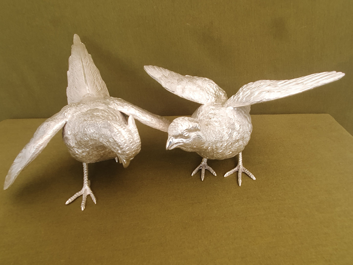 Pair of solid silver pheasants. Cast, fine hand chased detail. 1.945KG. 28 & 32 CM.