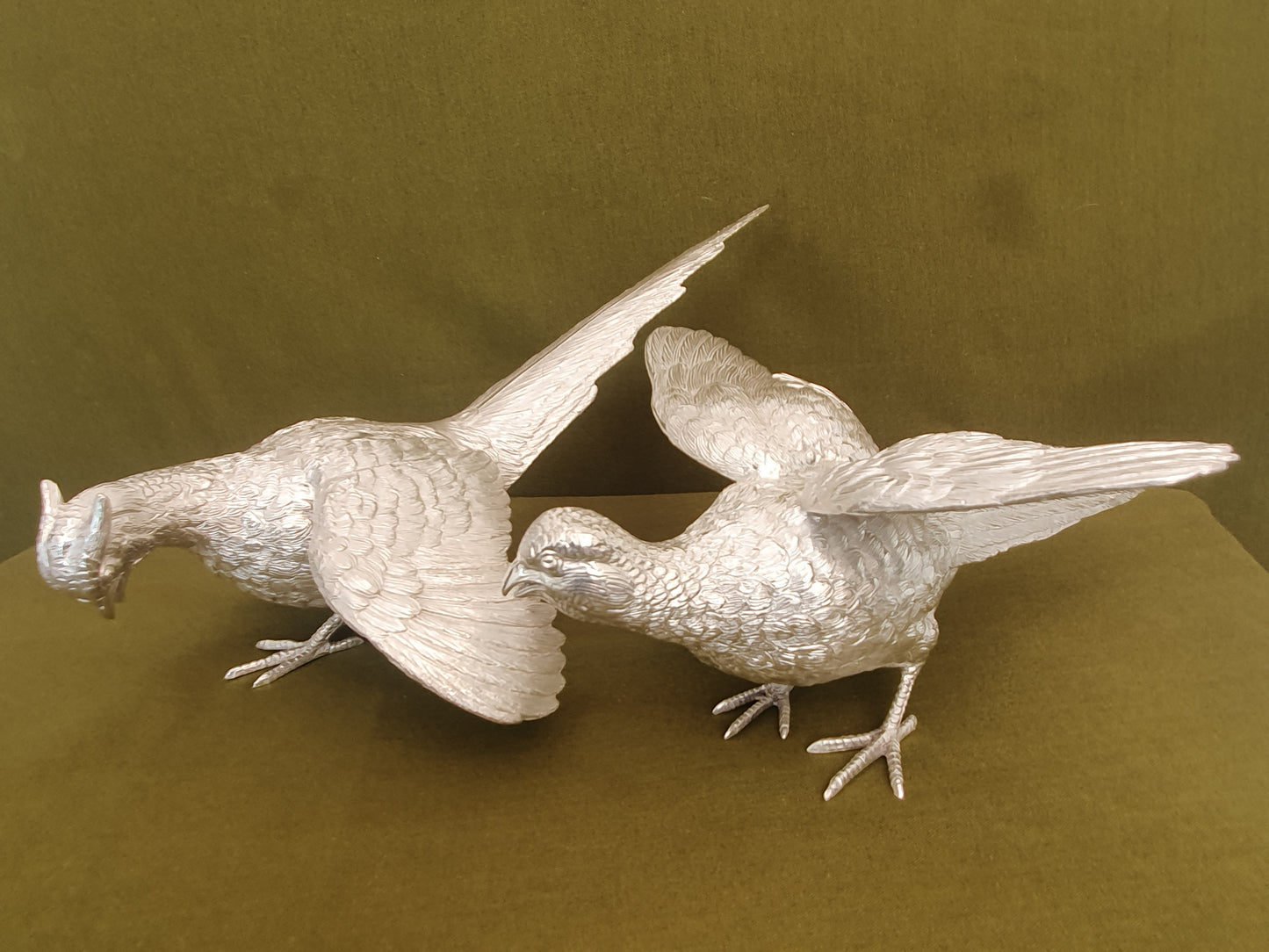 Pair of solid silver pheasants. Cast, fine hand chased detail. 1.945KG. 28 & 32 CM.