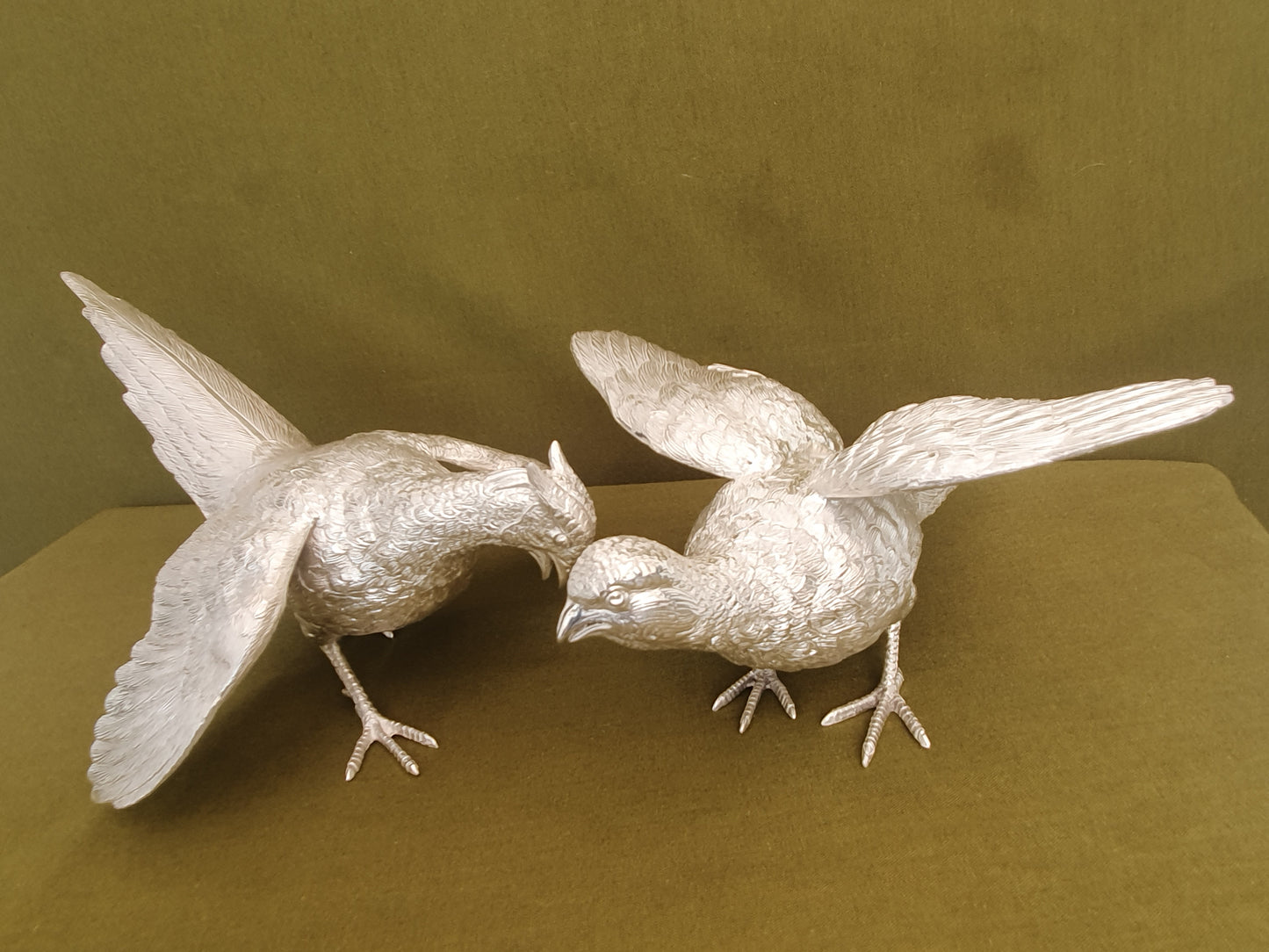 Pair of solid silver pheasants. Cast, fine hand chased detail. 1.945KG. 28 & 32 CM.
