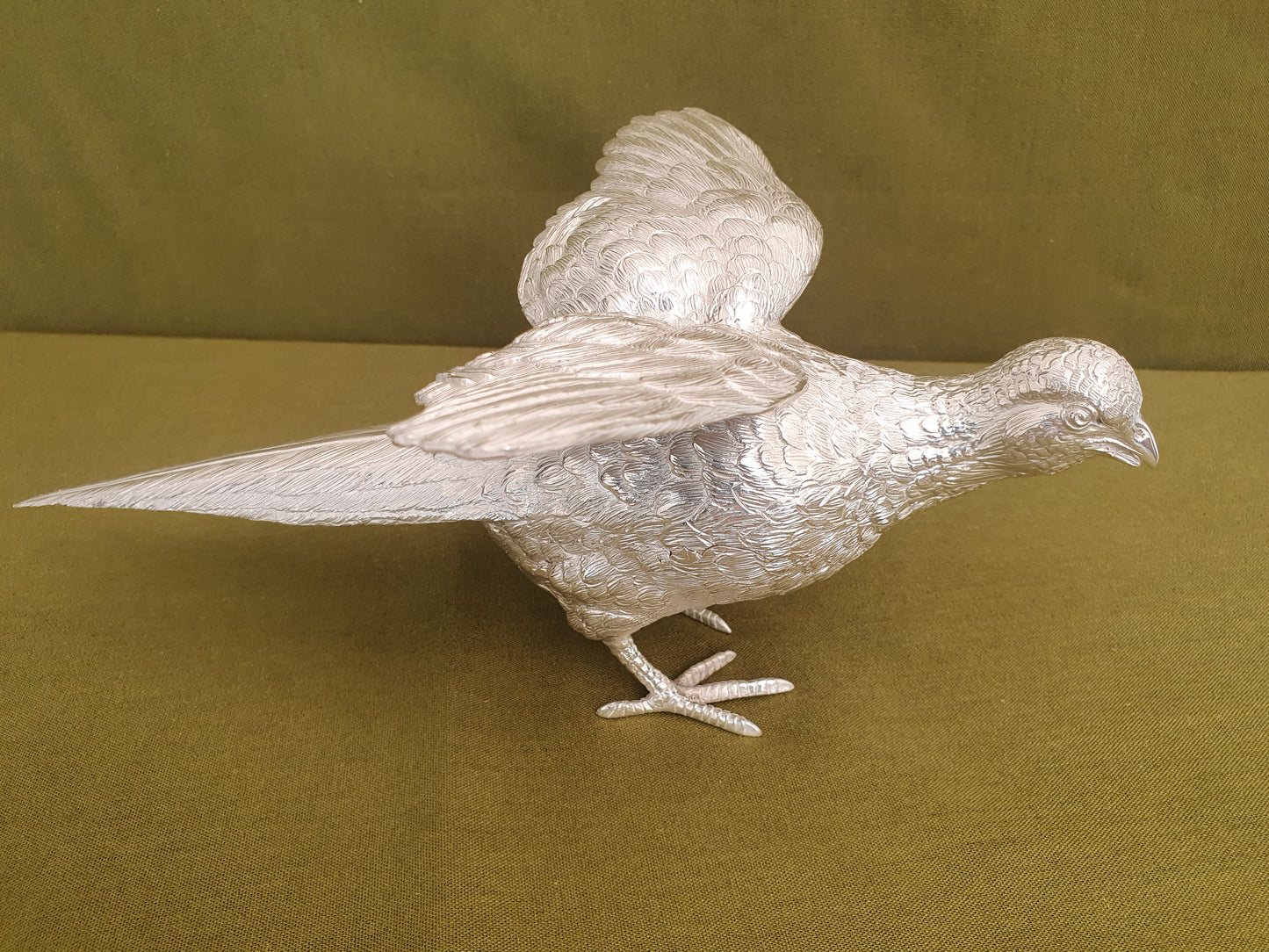 Pair of solid silver pheasants. Cast, fine hand chased detail. 1.945KG. 28 & 32 CM.