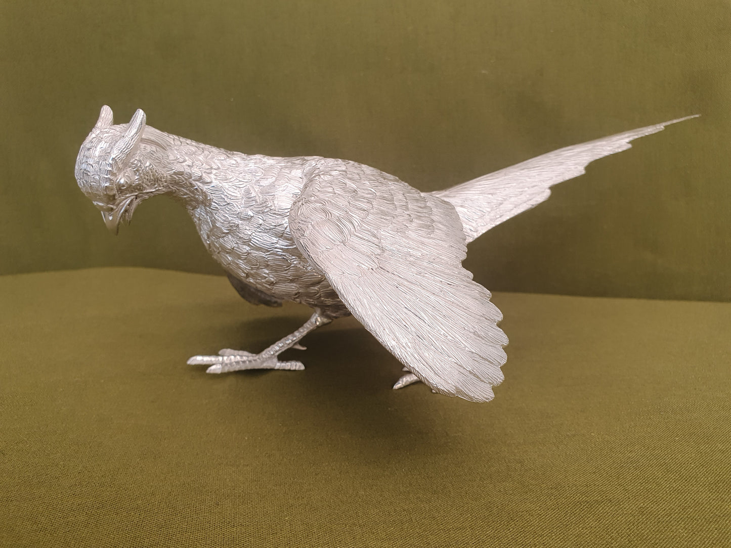 Pair of solid silver pheasants. Cast, fine hand chased detail. 1.945KG. 28 & 32 CM.