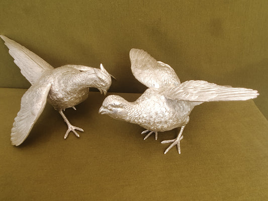 Pair of solid silver pheasants. Cast, fine hand chased detail. 1.945KG. 28 & 32 CM.